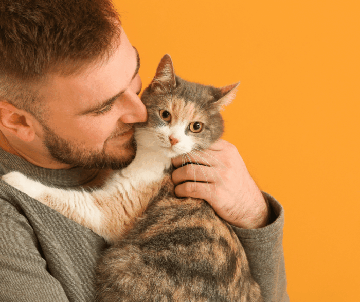 Man cuddling cat
