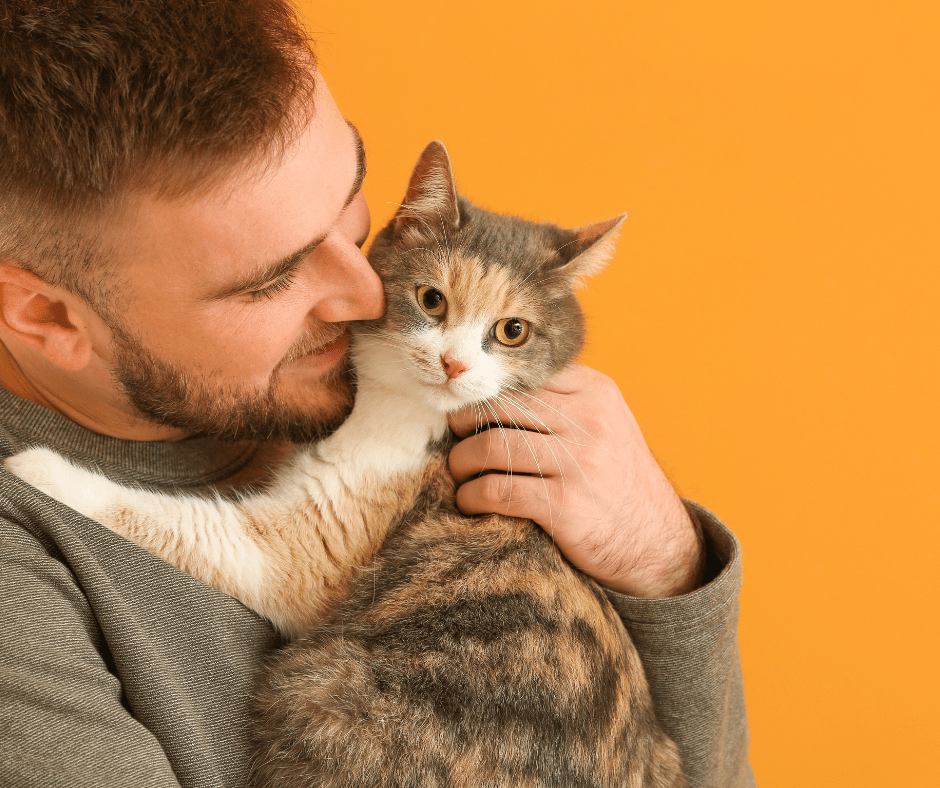 Man cuddling cat
